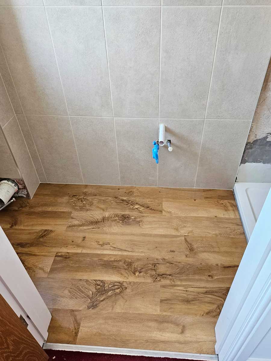Karndean oak effect luxury vinyl plank flooring installed by Room H2o in a small shower room in Swanage Dorset