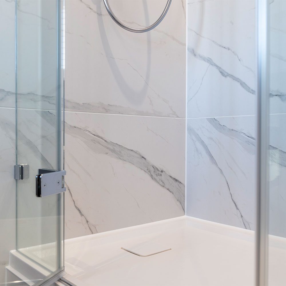 White stone effect Matki Preference shower tray with matching white waste