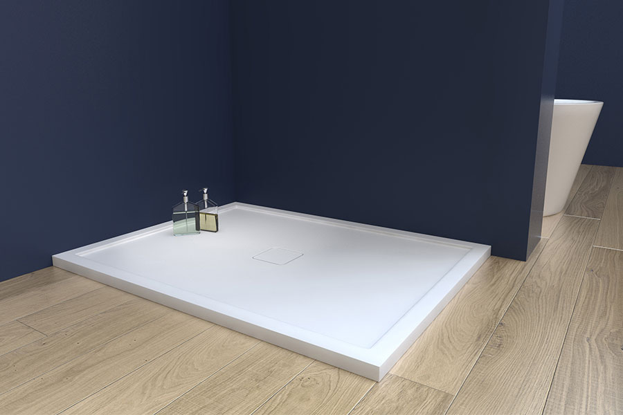 A Matki Preference low-profile shower tray made from solid surface stone material with matching waste cover in white