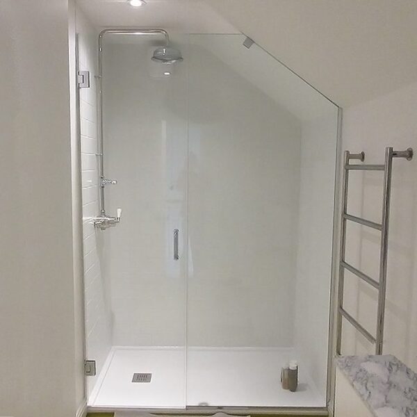 Bespoke inline shower door with angled panel by Room H2o in a loft conversion