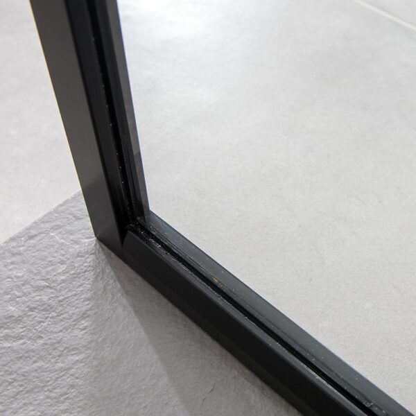 The slim frame detail of a Drench 8mm glass black shower screen