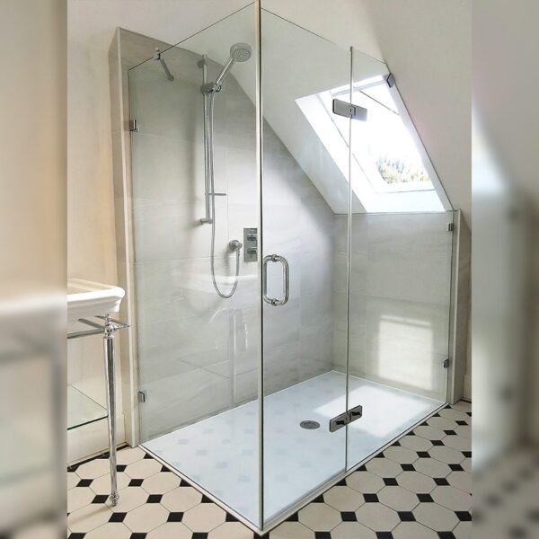 Bespoke frameless corner shower enclosure with angled inline panel by Room H2o in a loft conversion