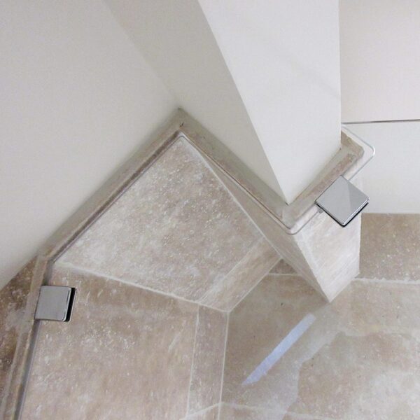 Bespoke framless glass shower screen shaped around the beams of a ceiling