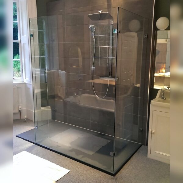 Large bespoke glass walk-in shower screen with 3 sides on a large flat tray by Room H2o