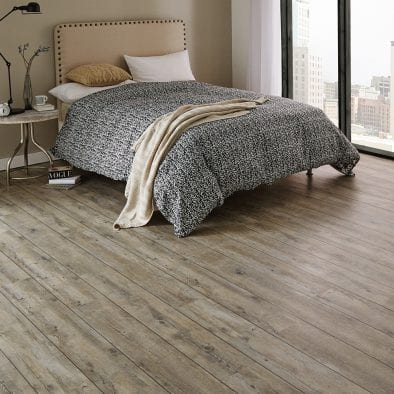 Karndean distressed Oak vinyl plank flooring in a bedroom setting