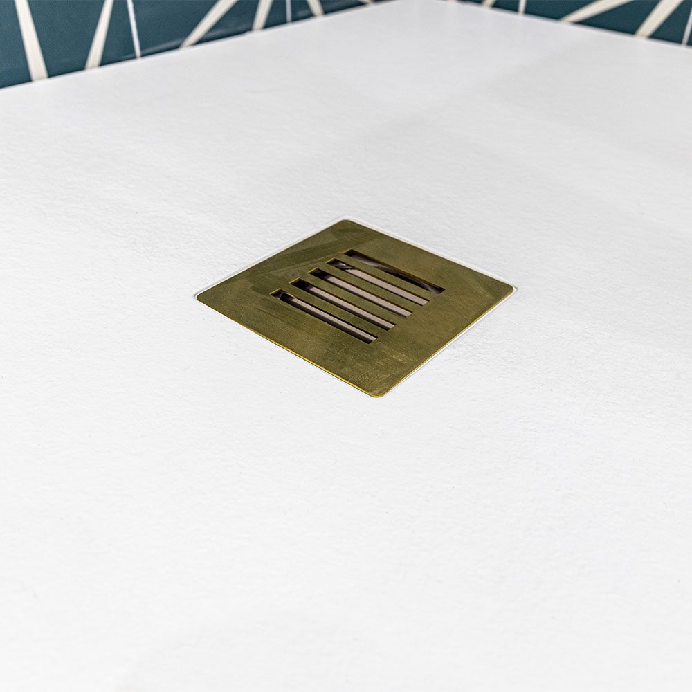 Drench Base white stone effect shower tray with brushed brass waste grate