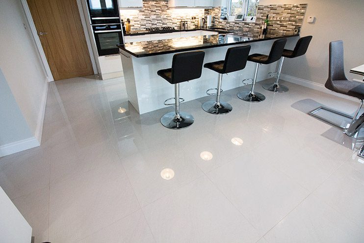 Large kitchen with white polished porcelain floor tiles and mosaic wall tiles