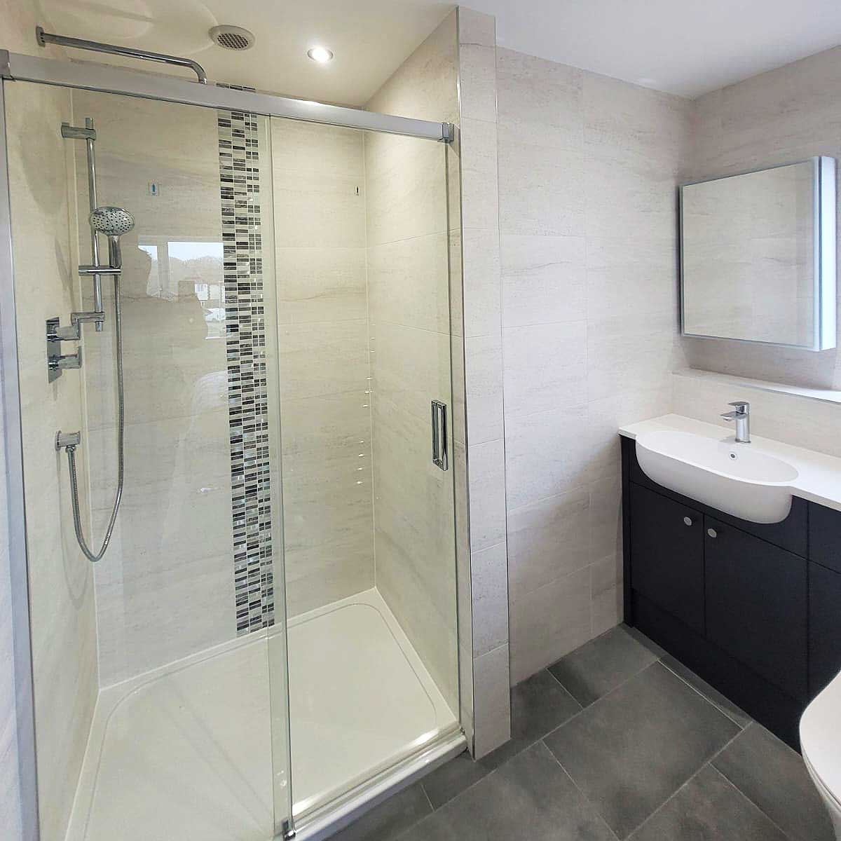 The new enlarged shower created by Room H2o for a customer in Dorset now features a hand shower and large drench shower head
